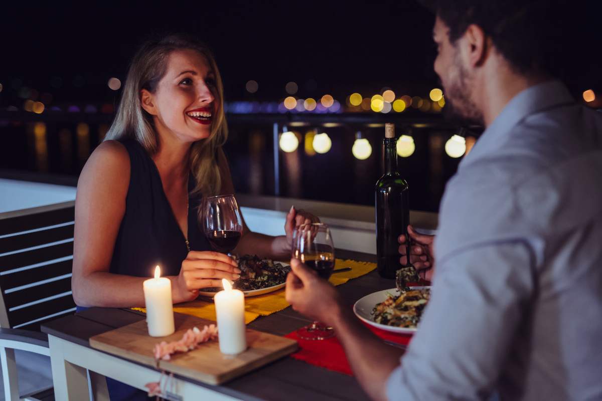 a man and woman on a date. she is talking and doesn't realize she's begun oversharing about her past.