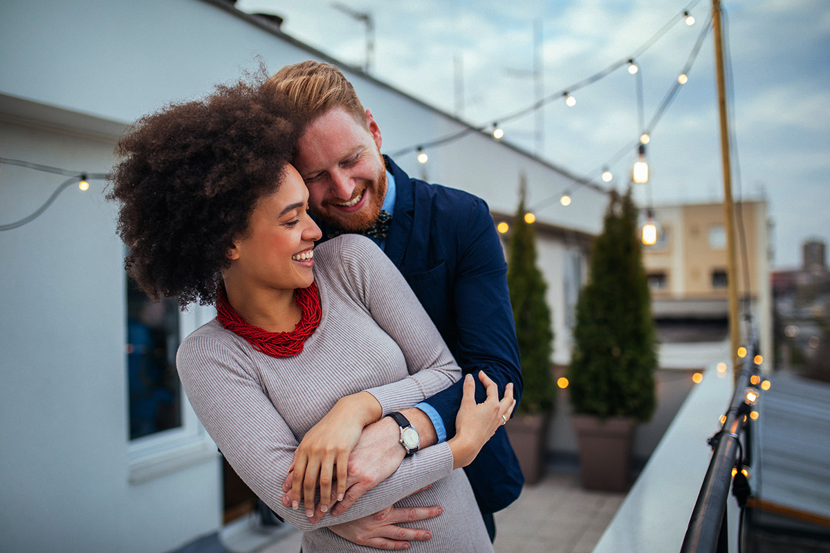 Happy Couple on Balcony - How to Date a Doctor