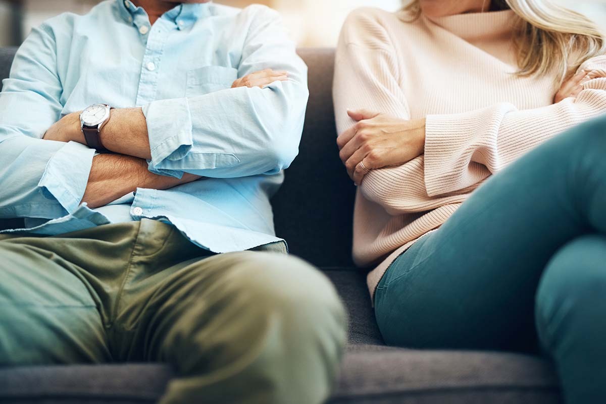 Couple Sits on Couch with Arms Folded - Imbalance in Your Relationship