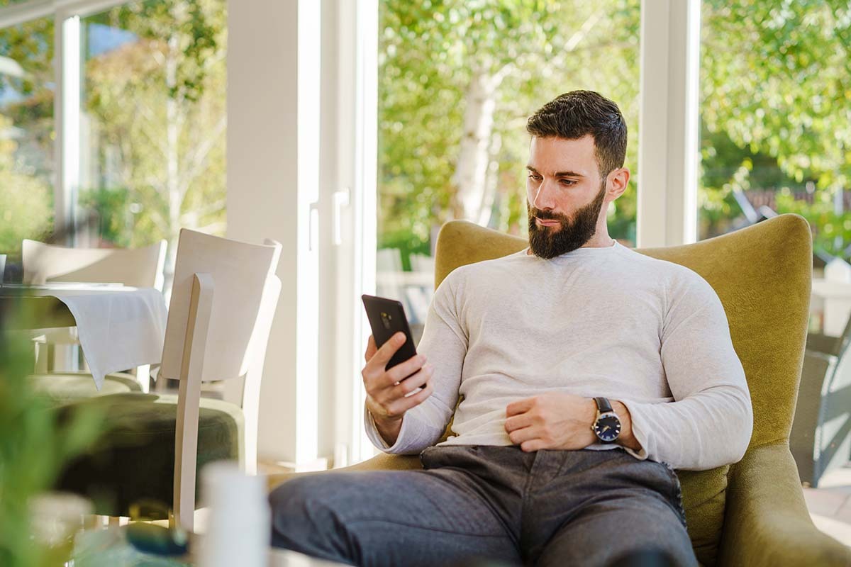 Handsome Man Looks at Phone after Zombieing Someone