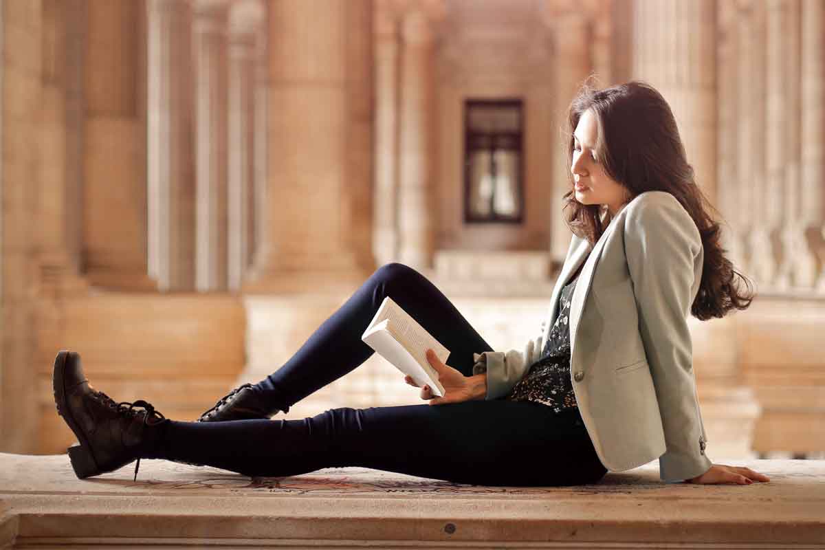 Woman Reading Dictionary of Dating at Museum