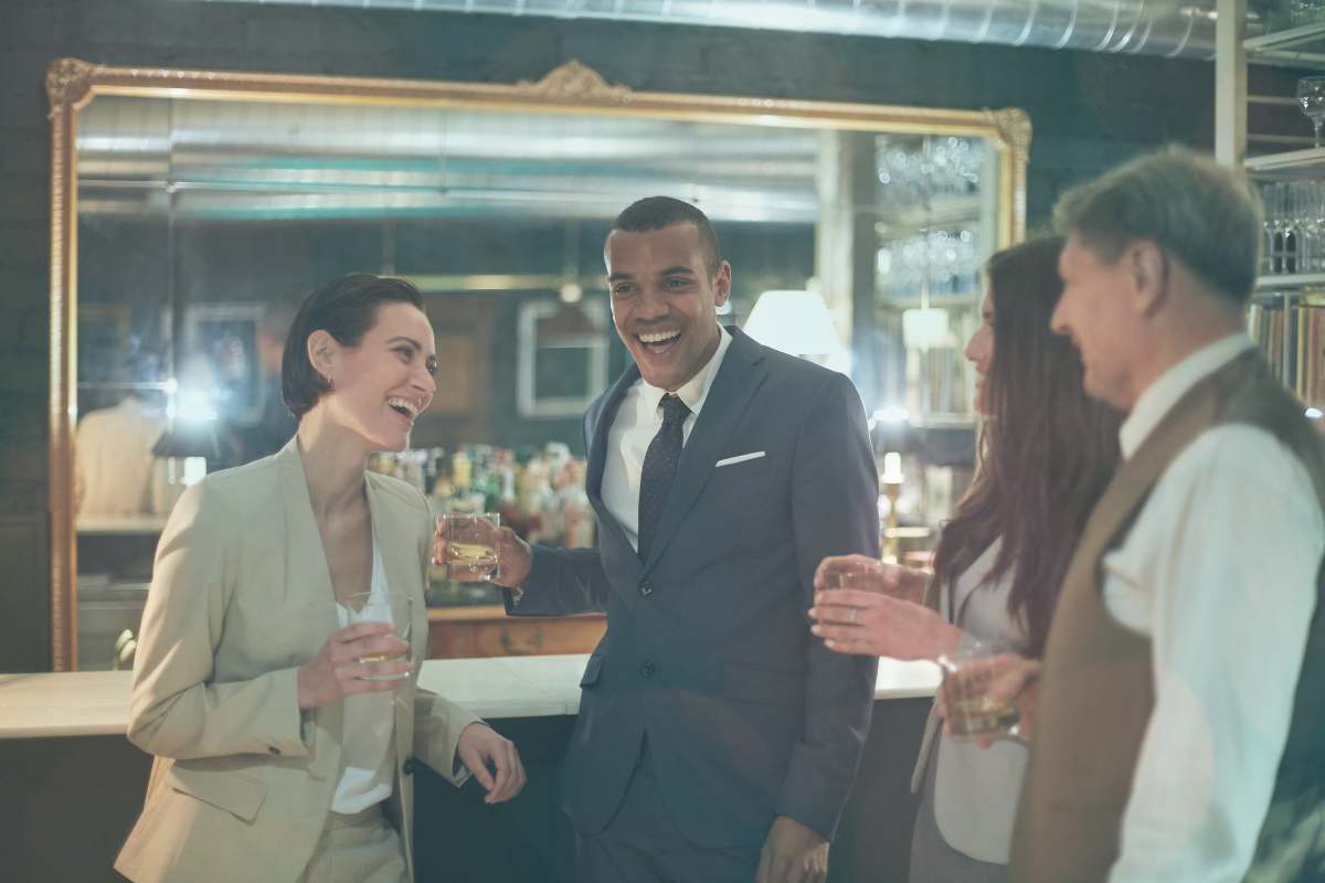 a man stands with a group of well-dressed friends. he wants to know how to tell people you're working with a matchmaker.