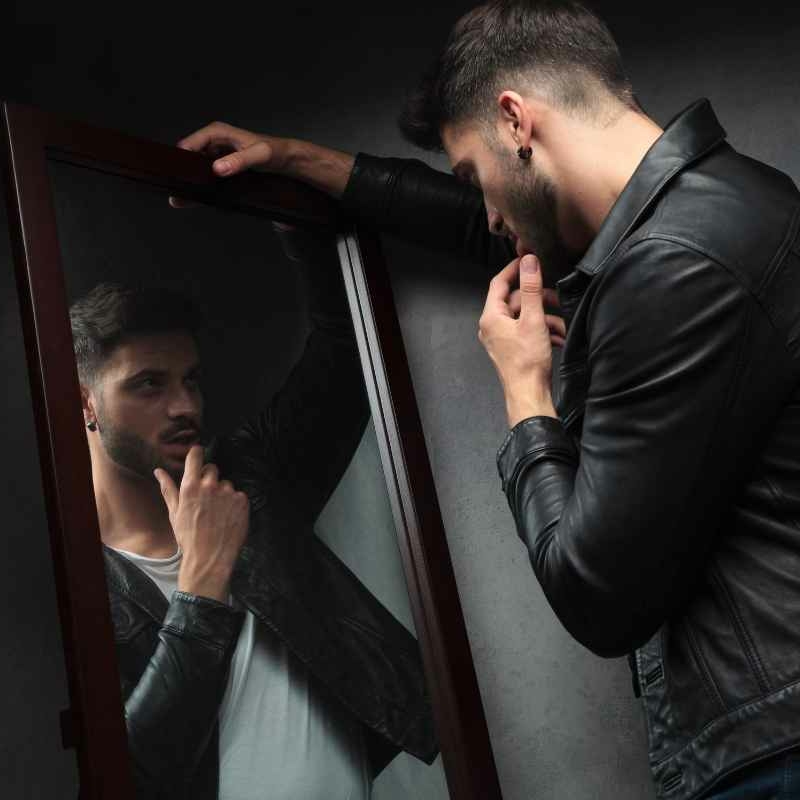 Man looking at himself in a mirror