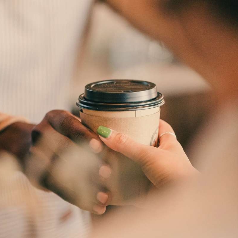barista handing coffee to customer