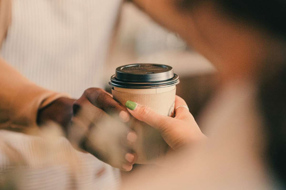 barista handing coffee to customer