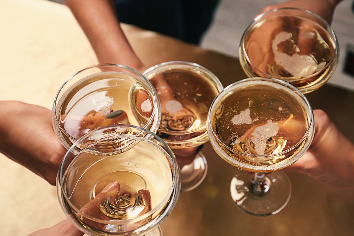 a group of people toasting their drinks.