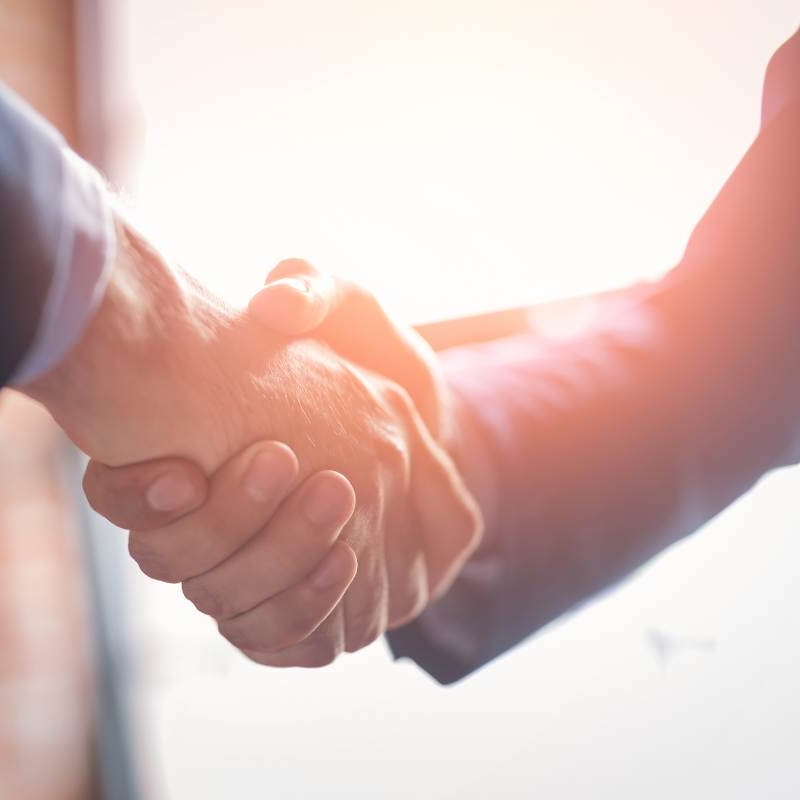 a handshake between a matchmaker and a client who has decided to invest in matchmaking services.