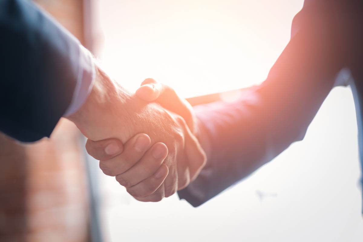 a handshake between a matchmaker and a client who has decided to invest in matchmaking services.