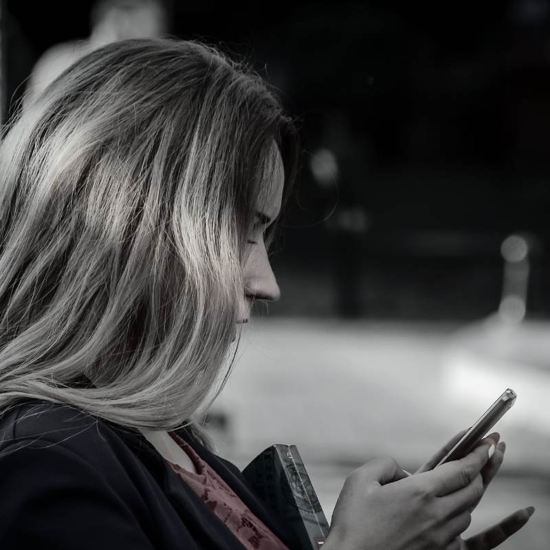 a beautiful woman scrolling on a dating app. she's about to give up on finding a good man here. she's outgrown dating apps.