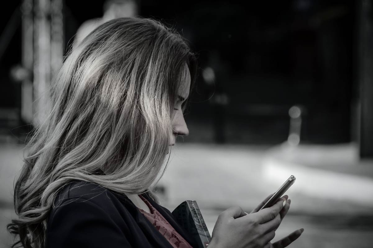 a beautiful woman scrolling on a dating app. she's about to give up on finding a good man here. she's outgrown dating apps.