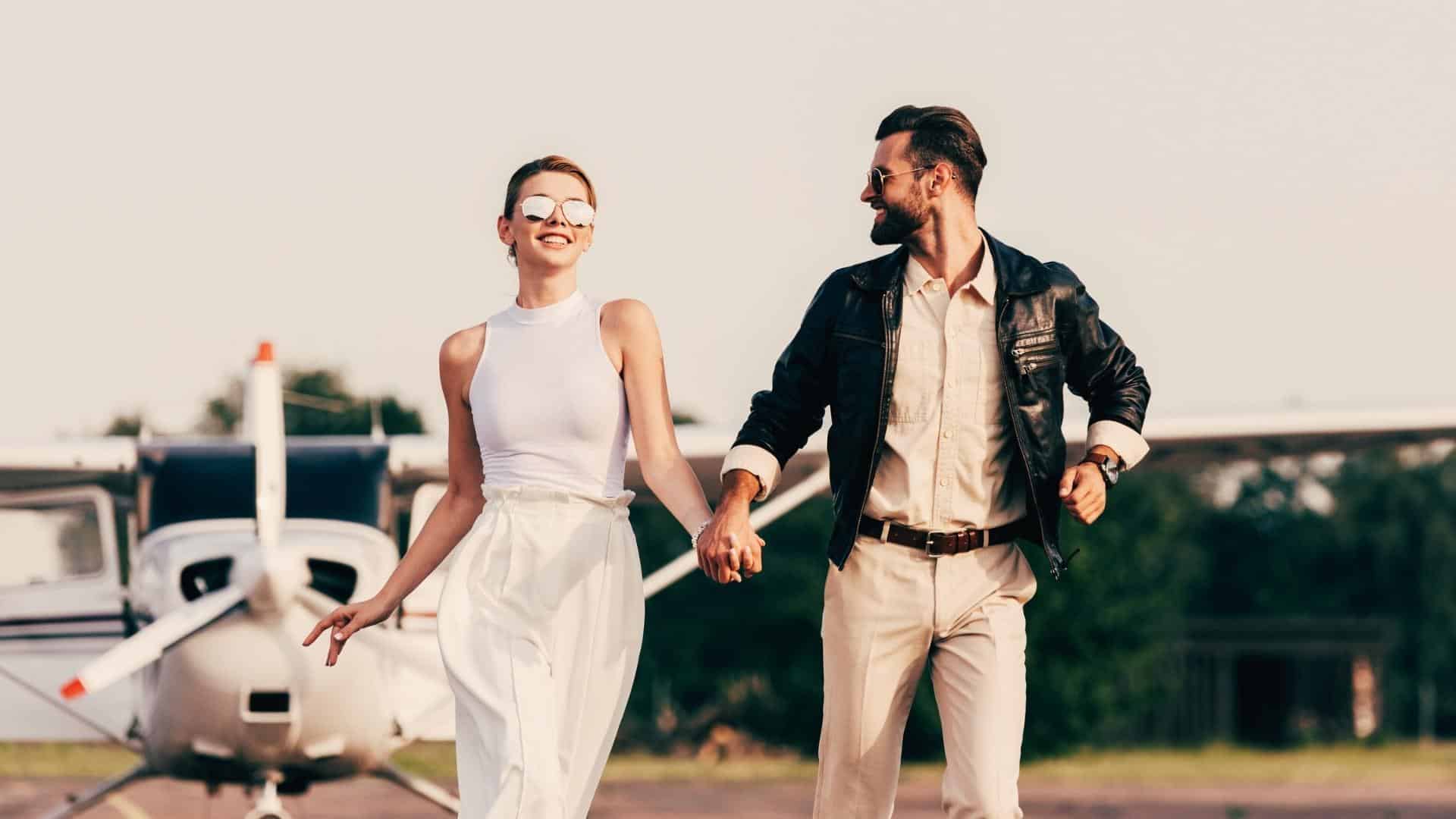 happy couple running away from airplane