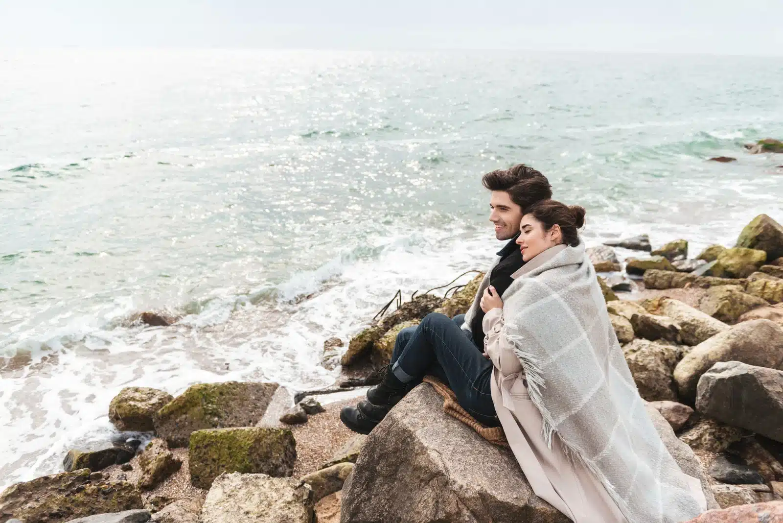 Happy couple at the beach in Autumn. She is not embarrassed to have a boyfriend.